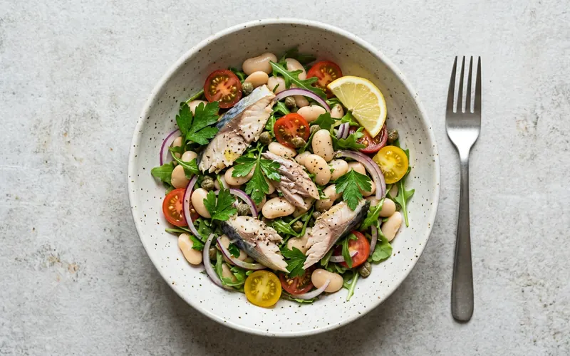 A bowl of mackerel, butter beans, cherry tomatoes and herbs