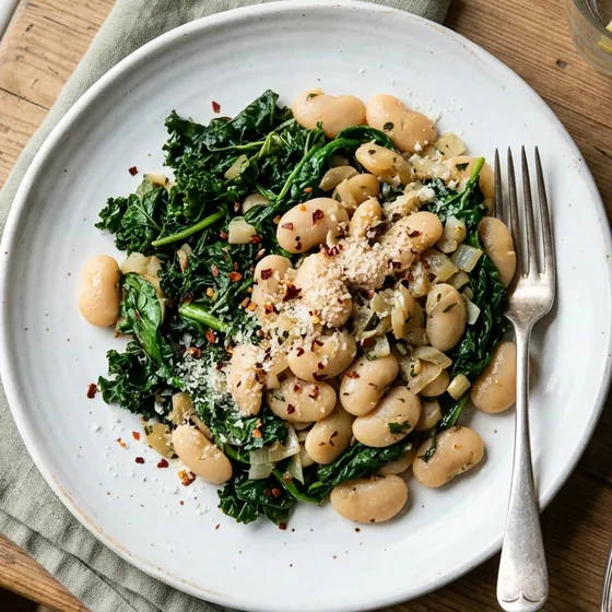 Butter beans and dark greens on a white plate